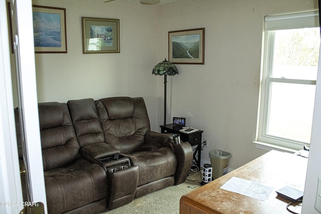 carpeted living room with ceiling fan