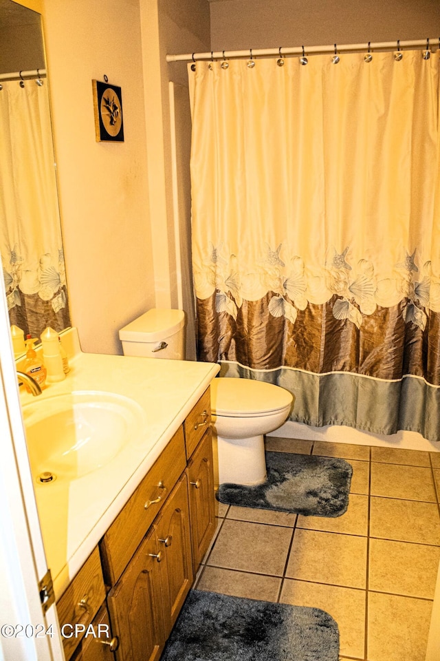 bathroom featuring tile patterned floors, vanity, and toilet