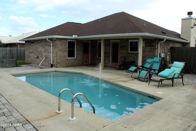 view of swimming pool featuring pool water feature and a patio area