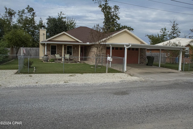 view of front of property with a porch, a front yard, and a carport