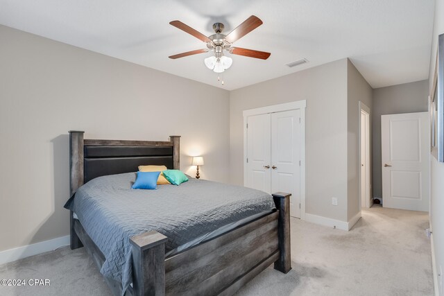 carpeted bedroom featuring ceiling fan and a closet