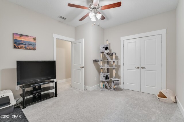 interior space featuring ceiling fan and light carpet