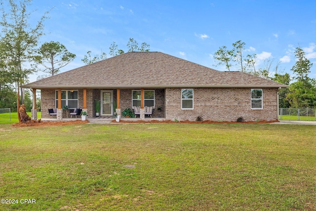 back of property featuring a yard