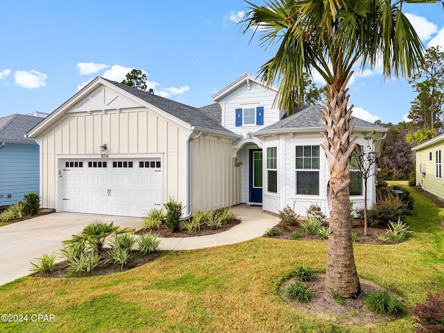 view of front of home featuring a front yard and a garage