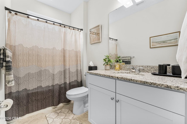 bathroom with tile patterned floors, vanity, and toilet