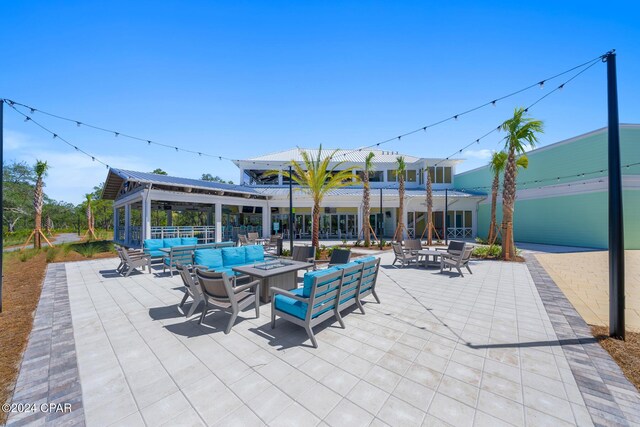 view of patio featuring an outdoor living space with a fire pit and a gazebo