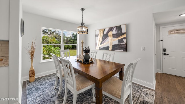 dining room with a chandelier and dark hardwood / wood-style flooring