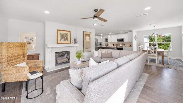 living room featuring ceiling fan and wood-type flooring