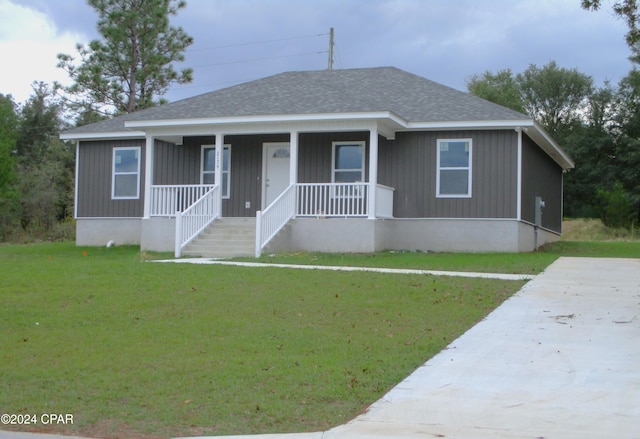 view of front of house with covered porch and a front yard