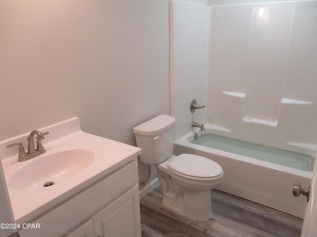 full bathroom with shower / tub combination, toilet, vanity, and hardwood / wood-style flooring