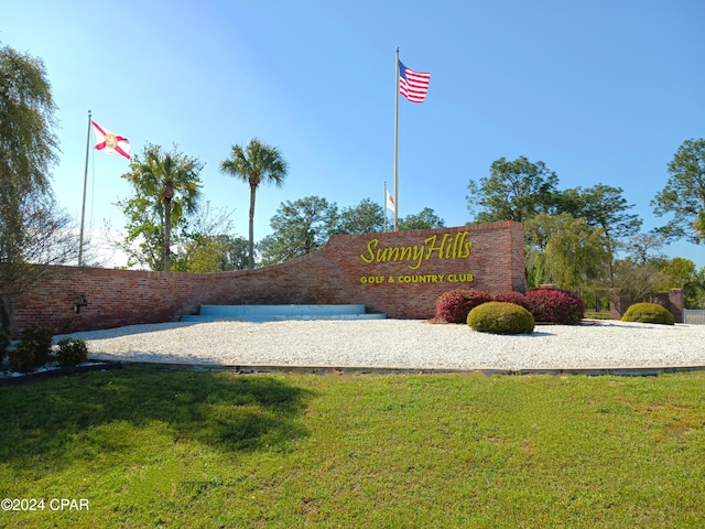 community / neighborhood sign featuring a yard