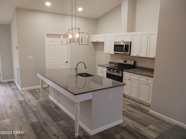 kitchen with white cabinetry, sink, dark hardwood / wood-style flooring, a center island with sink, and appliances with stainless steel finishes