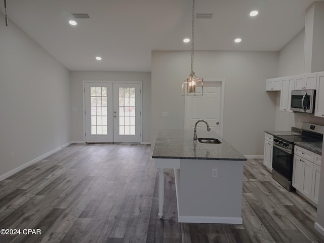 kitchen with sink, white cabinets, stainless steel appliances, and wood-type flooring