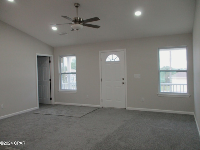 carpeted entrance foyer with ceiling fan and lofted ceiling