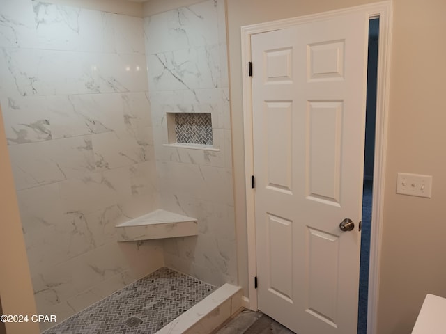 bathroom with a tile shower