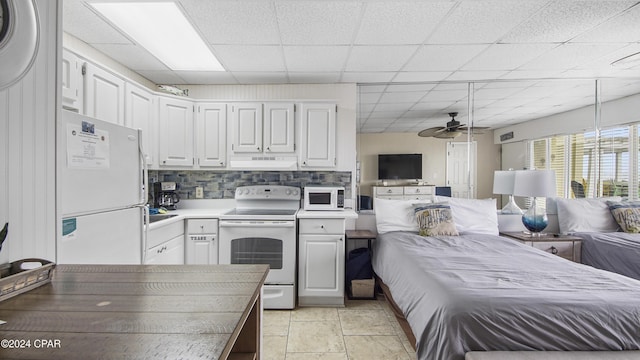 kitchen with decorative backsplash, white cabinetry, a drop ceiling, and white appliances