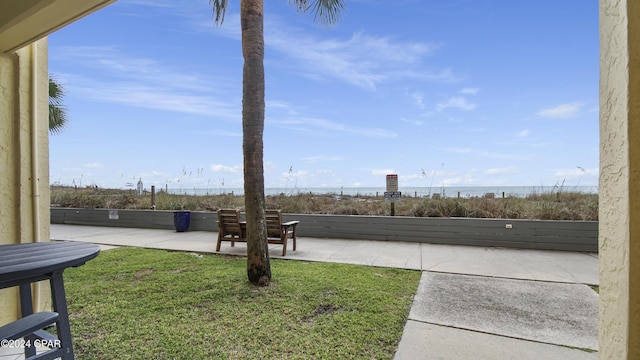 view of yard with a patio and a water view