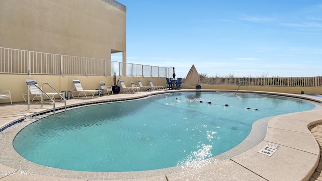 view of swimming pool featuring a patio area