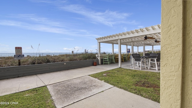 view of patio / terrace with a pergola and a water view