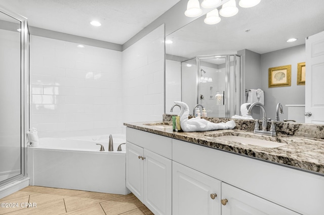 bathroom with vanity and separate shower and tub