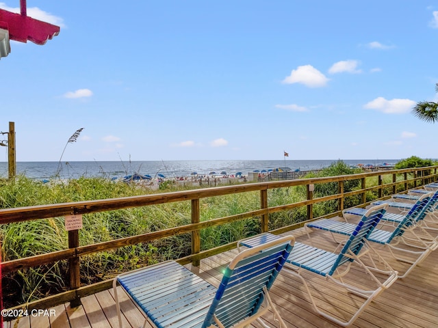 deck featuring a view of the beach and a water view