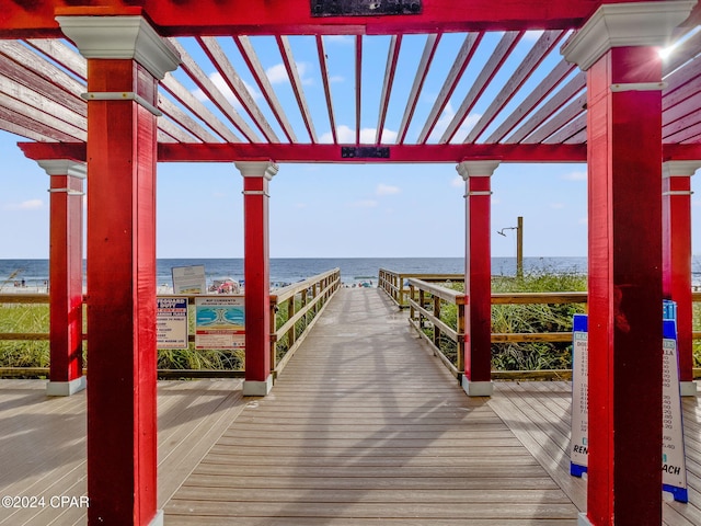 dock area with a pergola and a water view