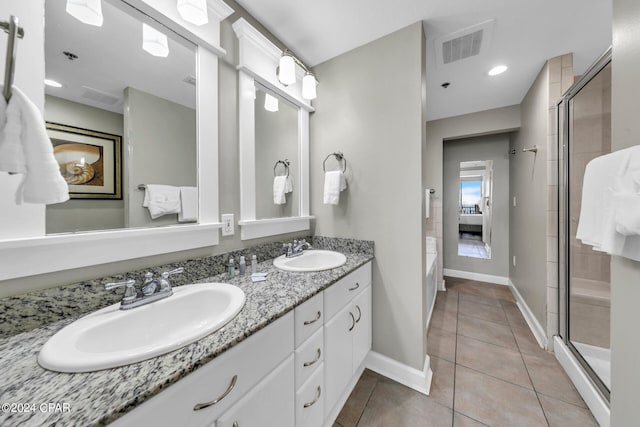 bathroom featuring vanity, tile patterned floors, and a shower with shower door