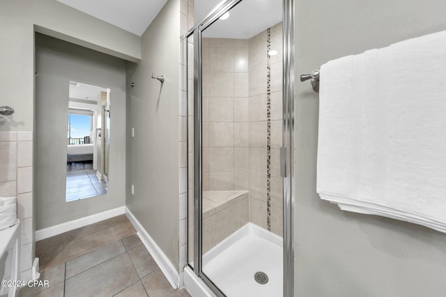 bathroom featuring tile patterned floors and a shower with shower door