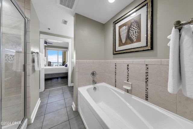 bathroom featuring separate shower and tub, tile patterned flooring, and tile walls