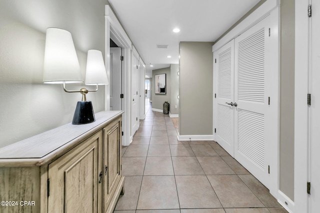 corridor featuring light tile patterned floors