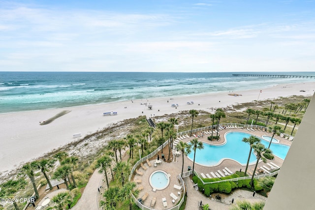 birds eye view of property featuring a beach view and a water view