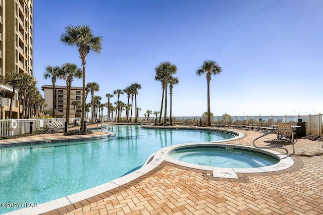 view of swimming pool featuring a community hot tub