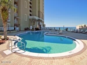 view of pool with a patio and a water view