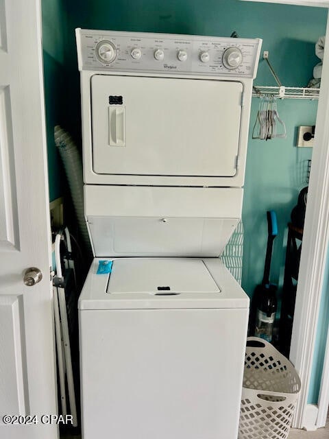 washroom featuring stacked washer and clothes dryer