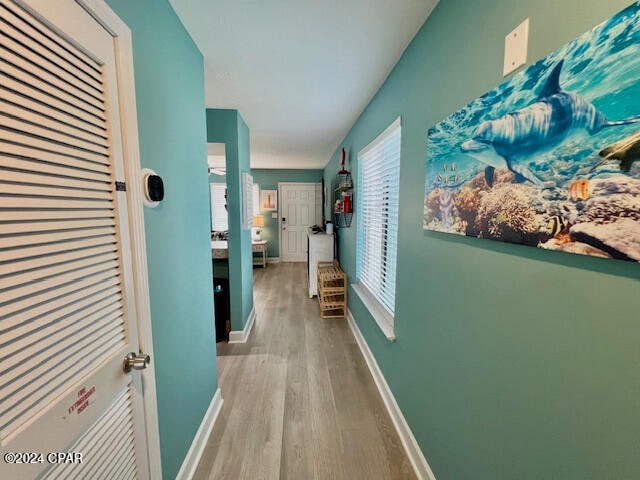 corridor with light wood-type flooring