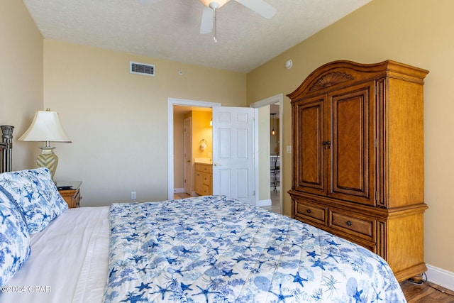 bedroom featuring ceiling fan, hardwood / wood-style floors, and a textured ceiling