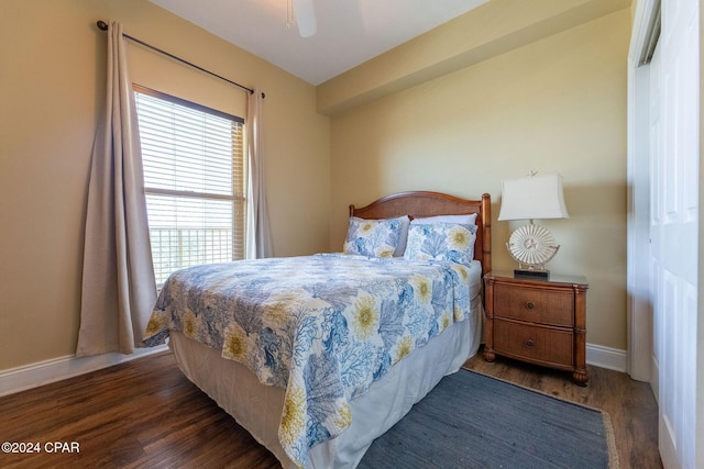 bedroom with ceiling fan and dark hardwood / wood-style floors