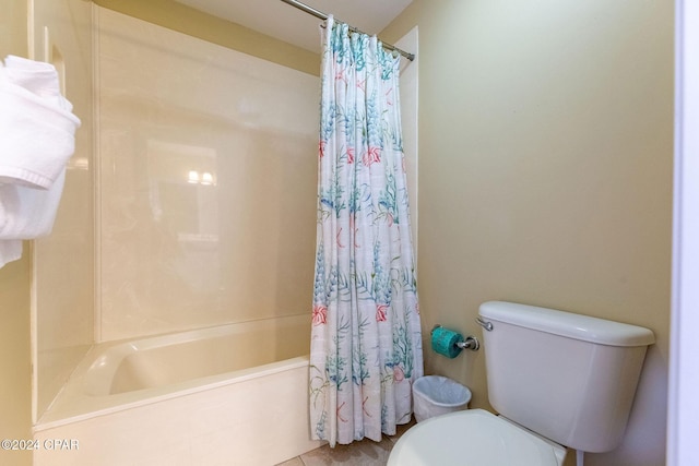 bathroom with shower / bath combination with curtain and toilet