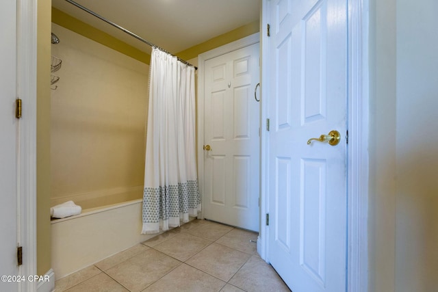 bathroom with tile patterned floors and shower / bath combination with curtain