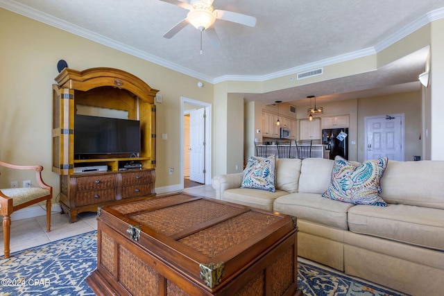 tiled living room featuring crown molding, a textured ceiling, and ceiling fan