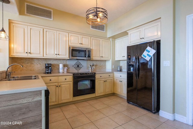 kitchen featuring sink, light tile patterned floors, tasteful backsplash, black appliances, and decorative light fixtures