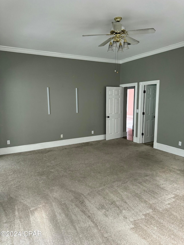 unfurnished room with carpet flooring, crown molding, and ceiling fan