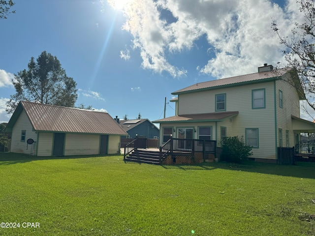 rear view of house featuring a yard, a deck, and an outdoor structure