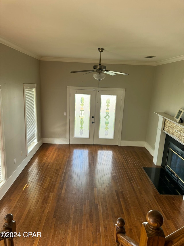 unfurnished living room with ceiling fan, dark hardwood / wood-style flooring, and ornamental molding