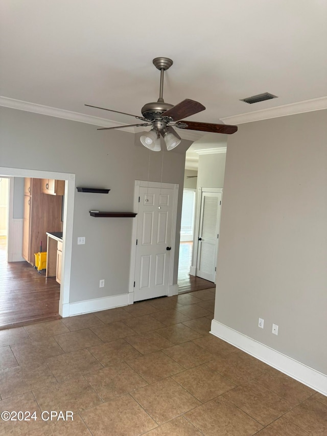 unfurnished living room with hardwood / wood-style flooring, ceiling fan, and crown molding