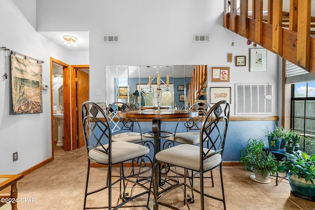 dining space featuring light tile patterned flooring