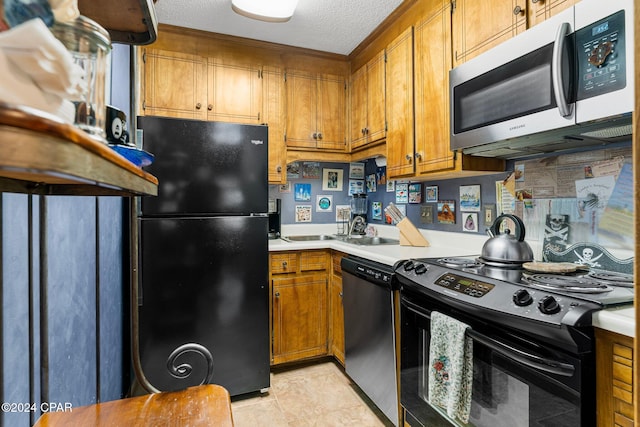 kitchen featuring black appliances, light tile patterned floors, sink, and a textured ceiling