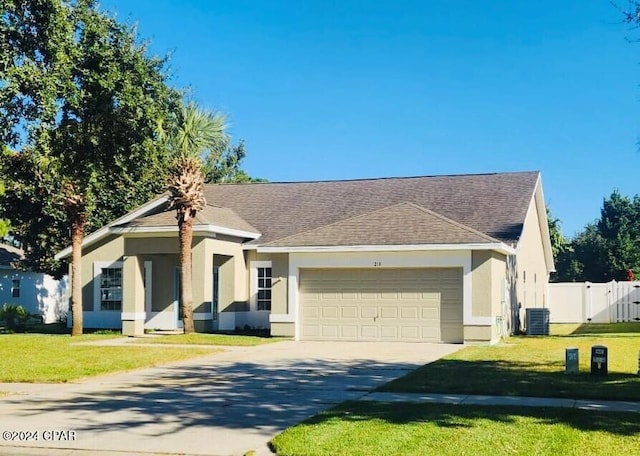 single story home with a garage, a front yard, and cooling unit