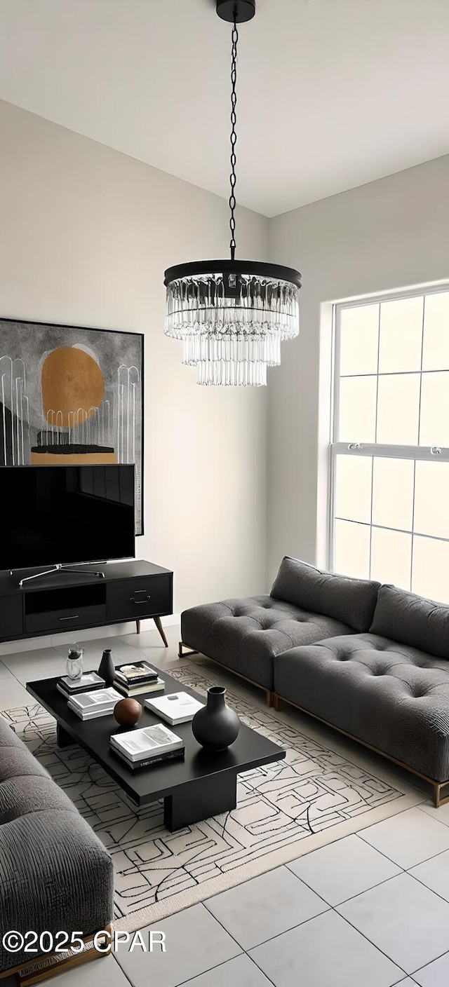 tiled living room with a notable chandelier