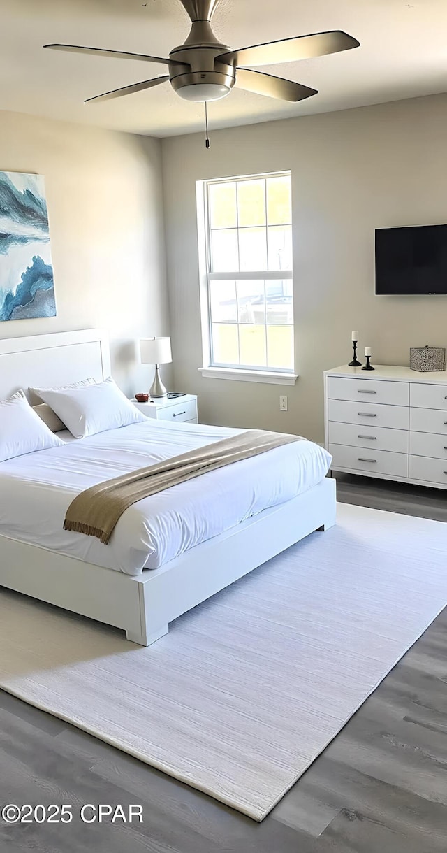 bedroom featuring dark hardwood / wood-style floors and ceiling fan